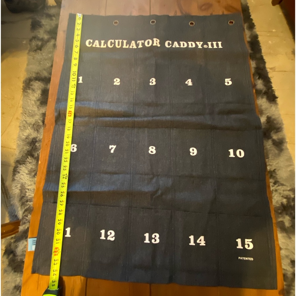 Calculator caddy wall hanging cell phone